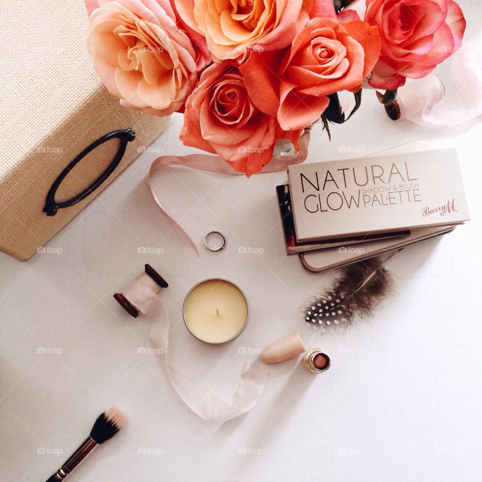 Greeting flat lay: flowers roses, box, candle and eyeshadows 