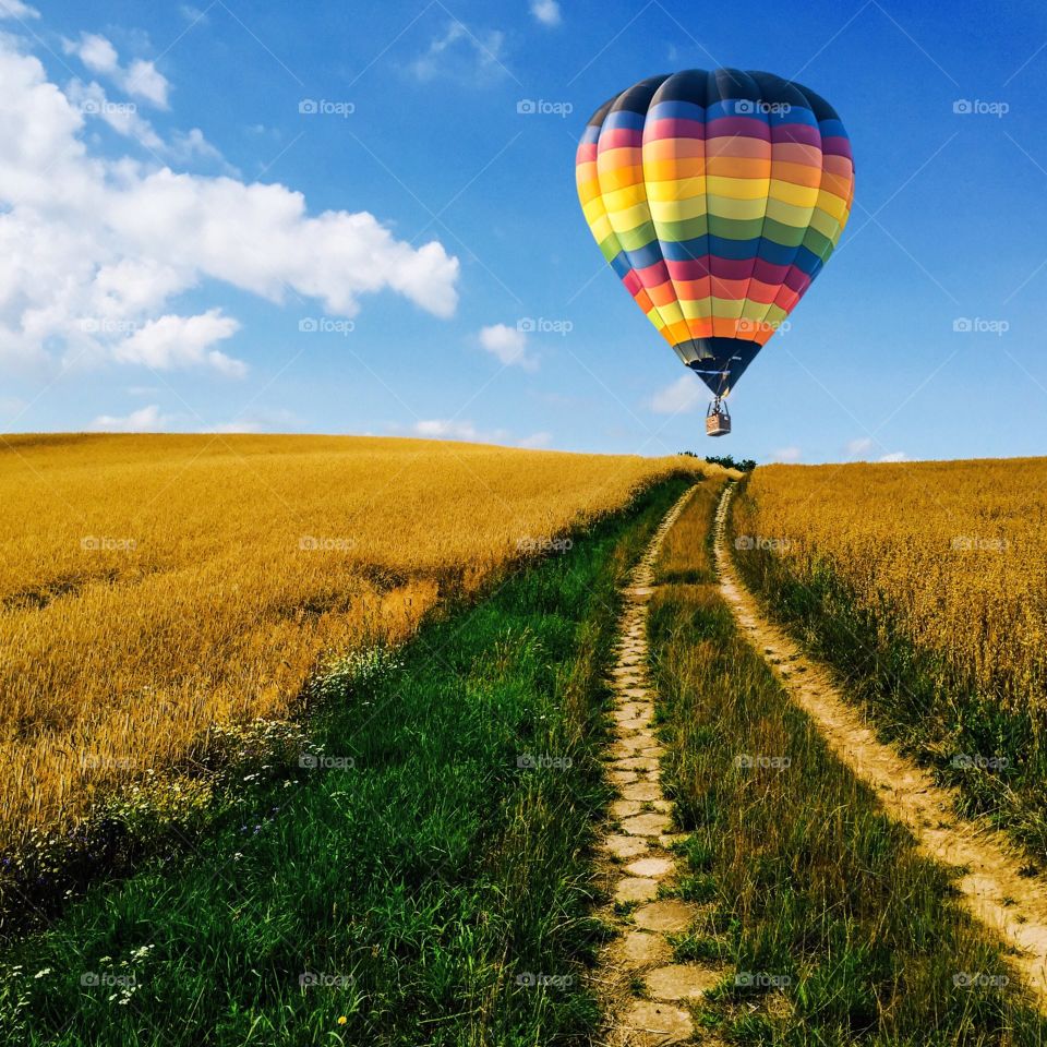 Hot air balloon over autumn field