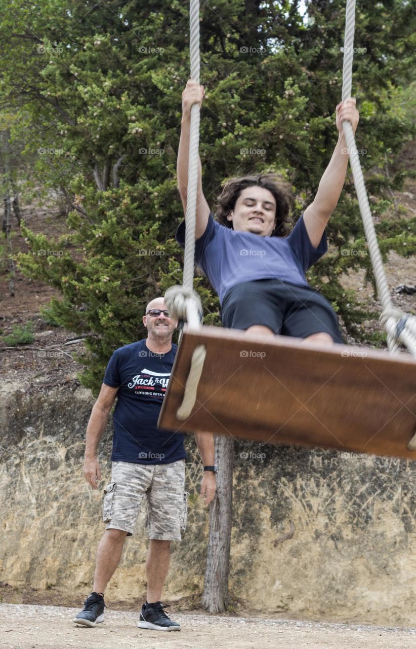 Fatherhood = you pushing your adult children on the swing