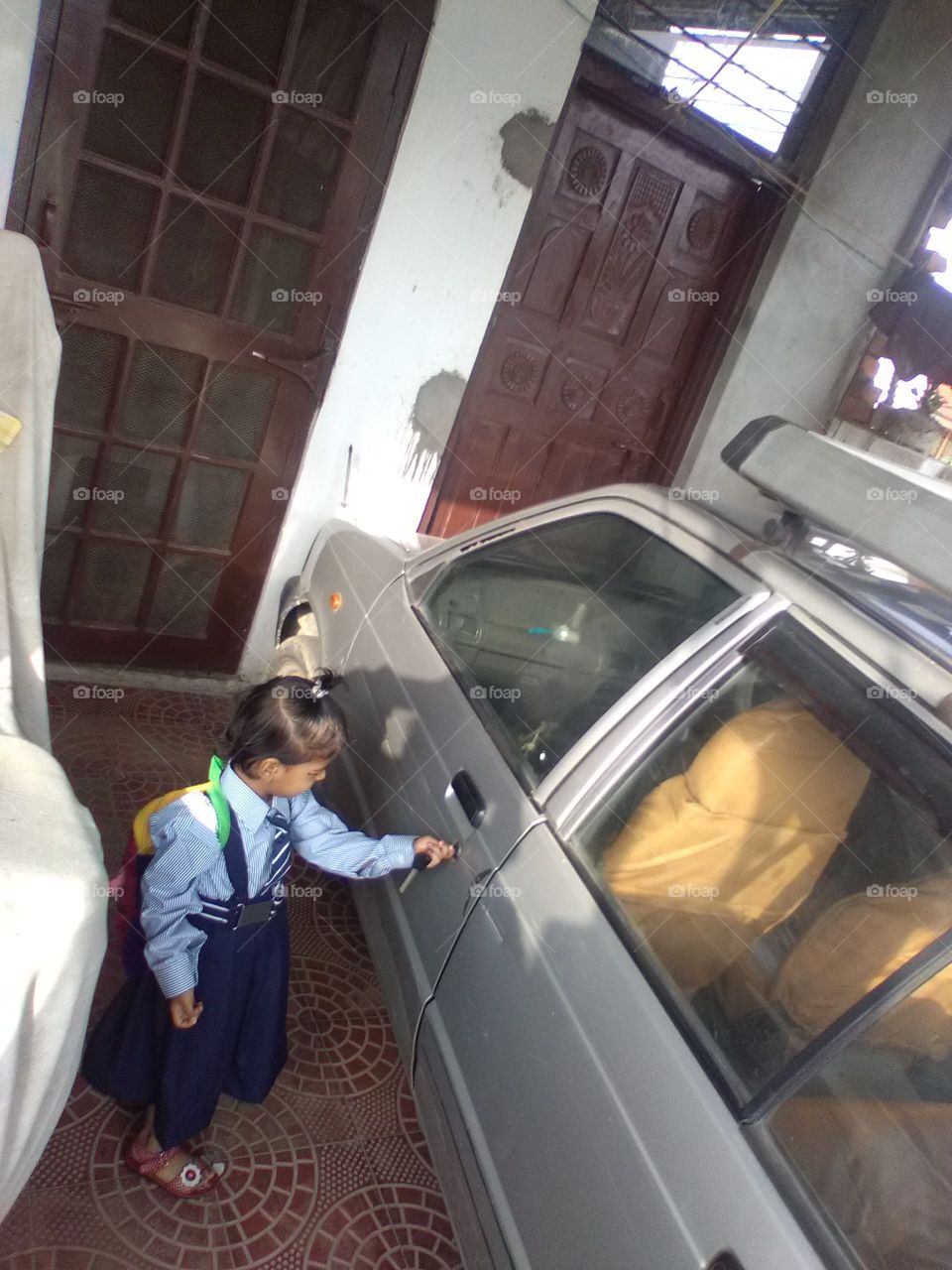 The child opening the car door