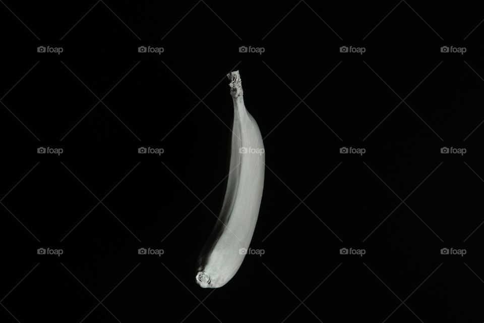 White floating banana on black backgroun. Creative fruit concept