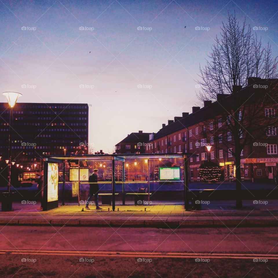 Bus stop in the city by night