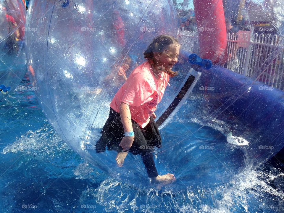 Child walking on water in amusement ride ball. Child walking on water in amusement ride ball