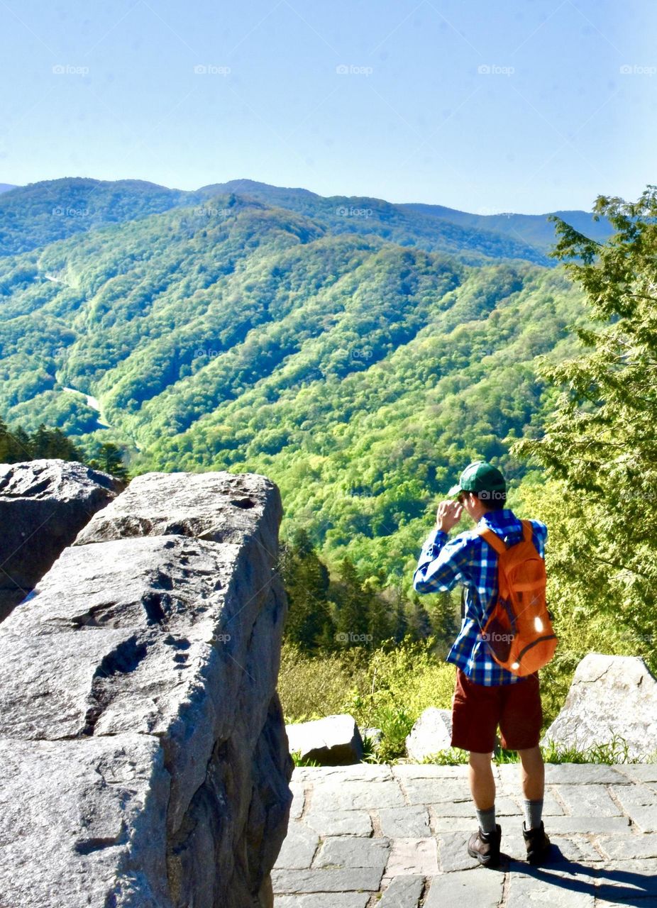 Man with backpack looking at mountains