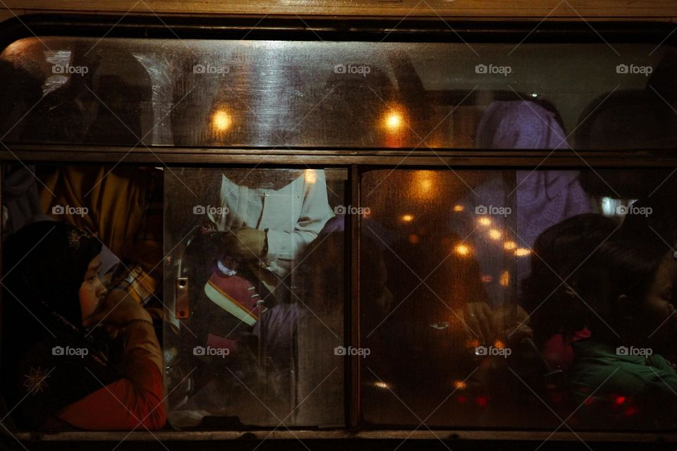 Portrait of a bus passenger sleeping in a passenger seat, whether blindfolded or not, Yogyakarta, Indonesia.