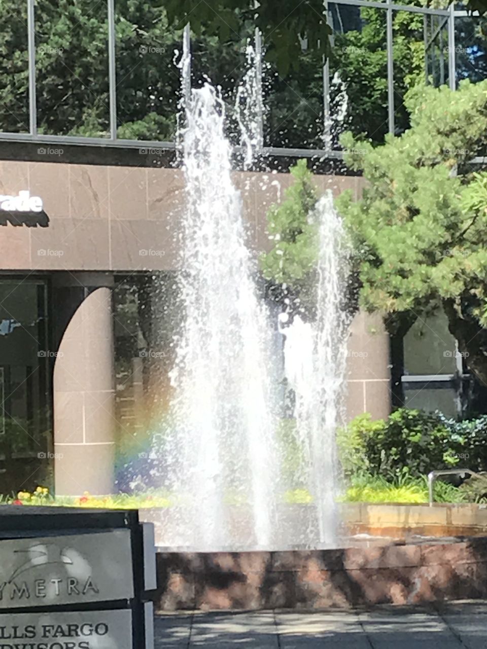 A fountain in Bellevue with the rainbow