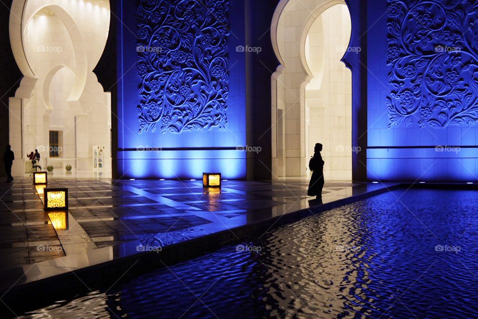 silhouette of a girl against the background of the world's largest mosque, beautiful lighting of facades, evening