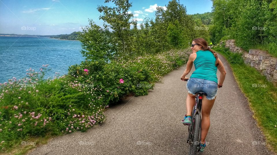 Rear view of woman cycling on road
