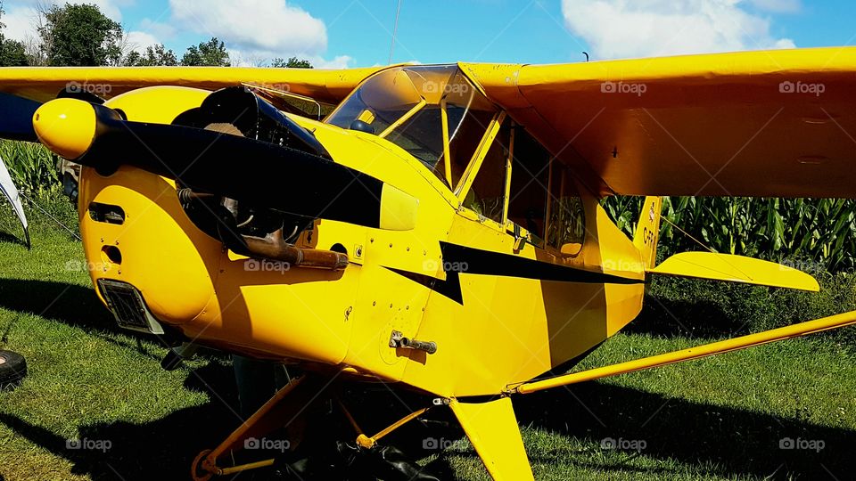 getting ready for a flight in a little yellow plane.