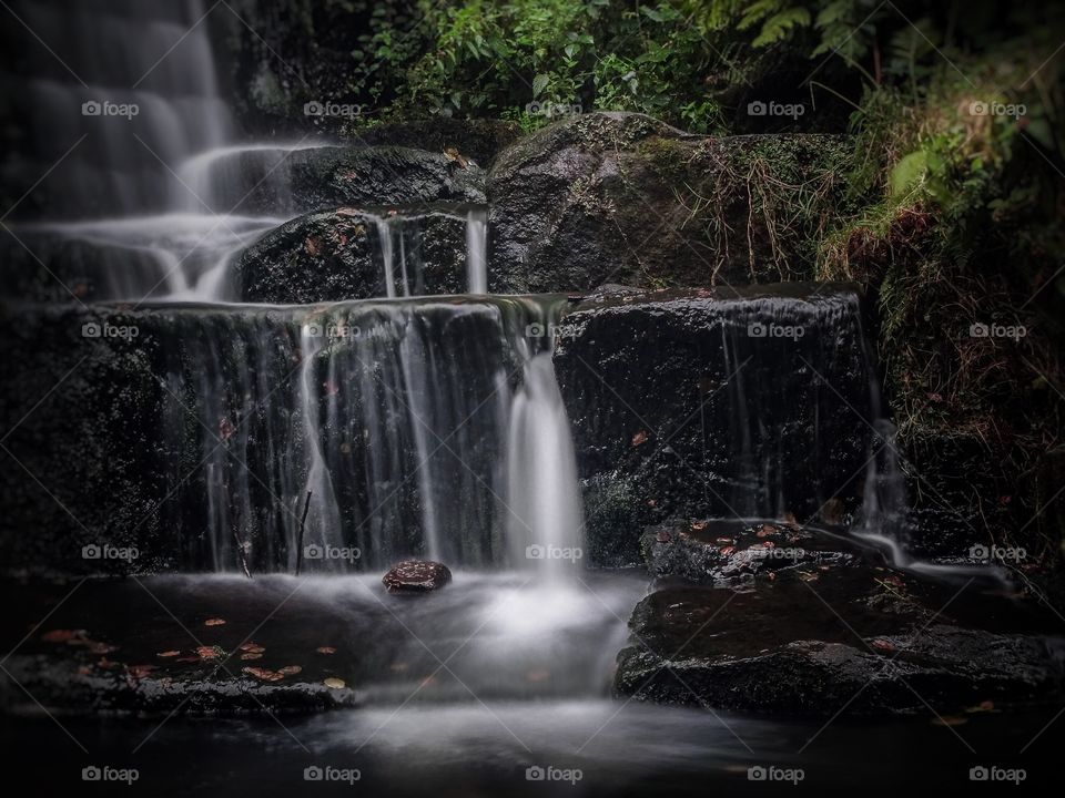 Gentle waterfall flows over rocks