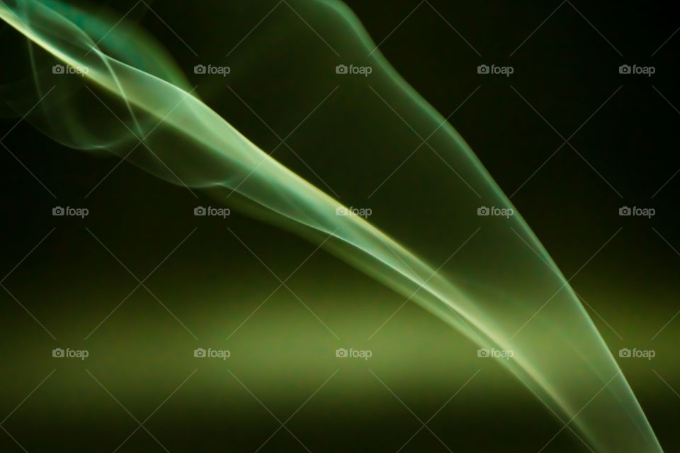 Smoke scented candles on a black background