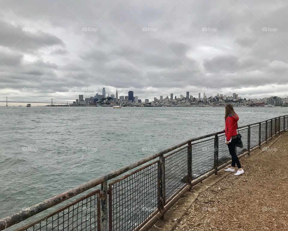 Checking out the city scape view from Alcatraz island over to San Francisco with moody skies overhead 