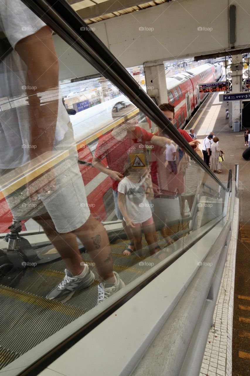 Going up with escalator at the train station 