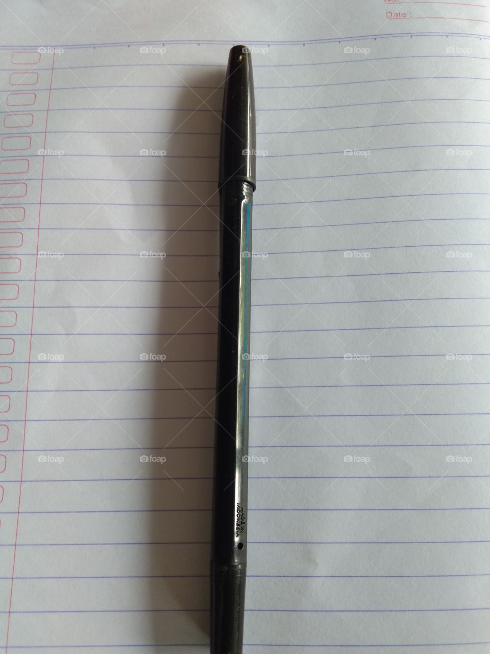 black pens above the striped book