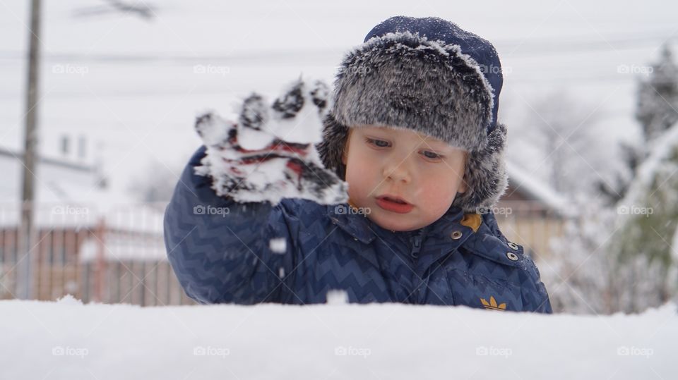 Small boy playing in snow