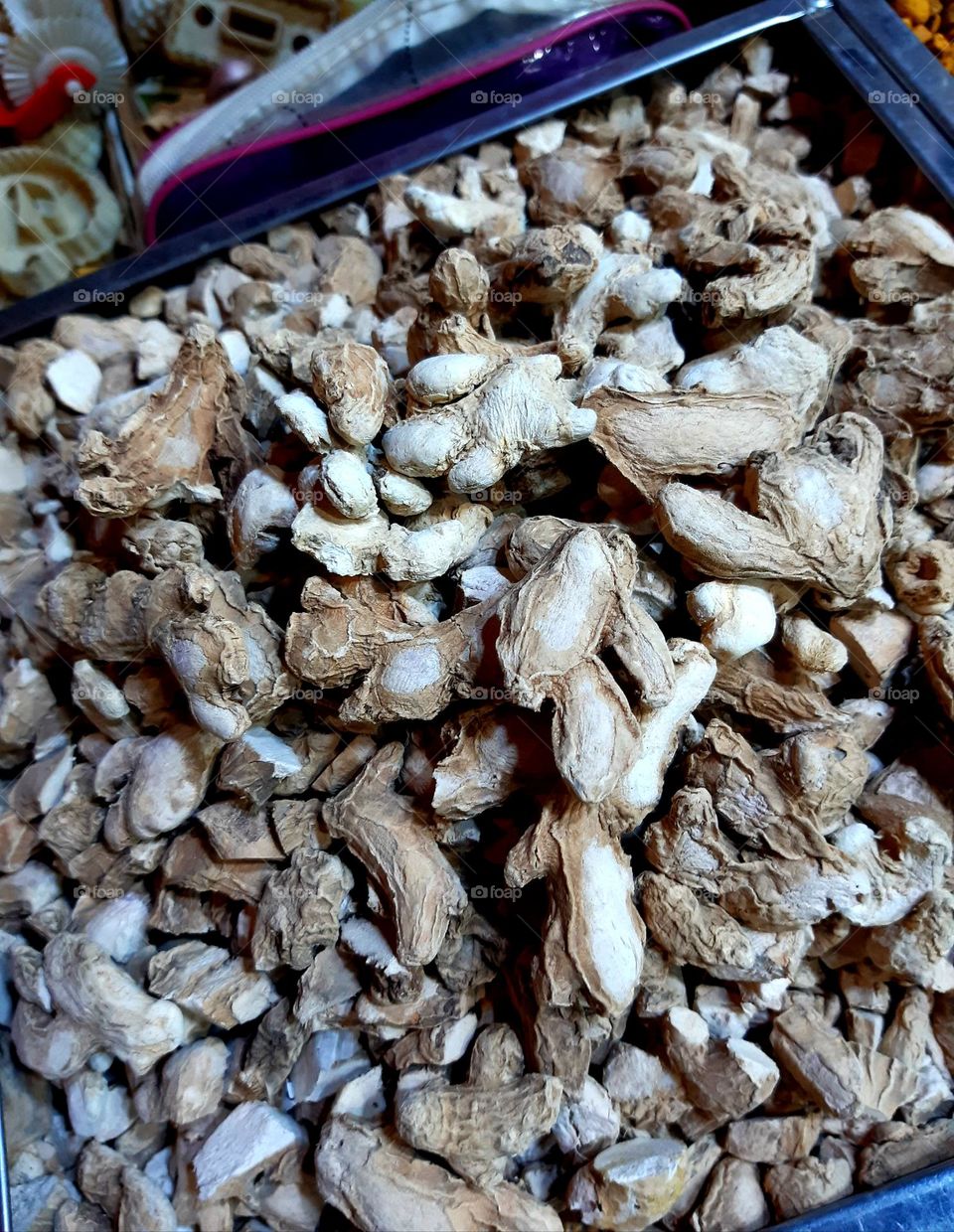 A close-up of dried ginger in a traditional market in Marrakech, showing its rough texture and natural brown shades. Captured on February 9, 2025.