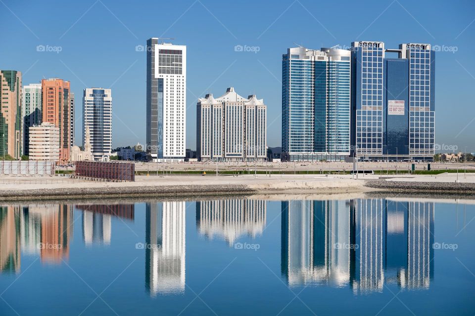 Abu Dhabi cityscape with sea reflection