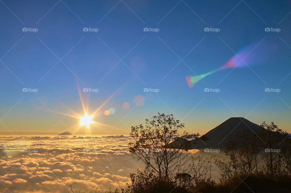 Panoramic view of Sea of clouds on colorful sunset in the mountains.