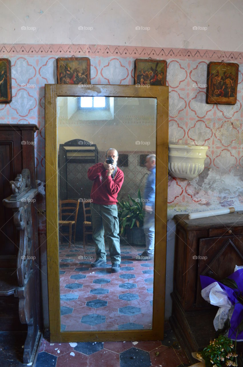 Man taking photograph in mirror