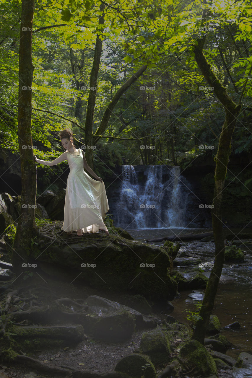 Woman standing near the waterfall