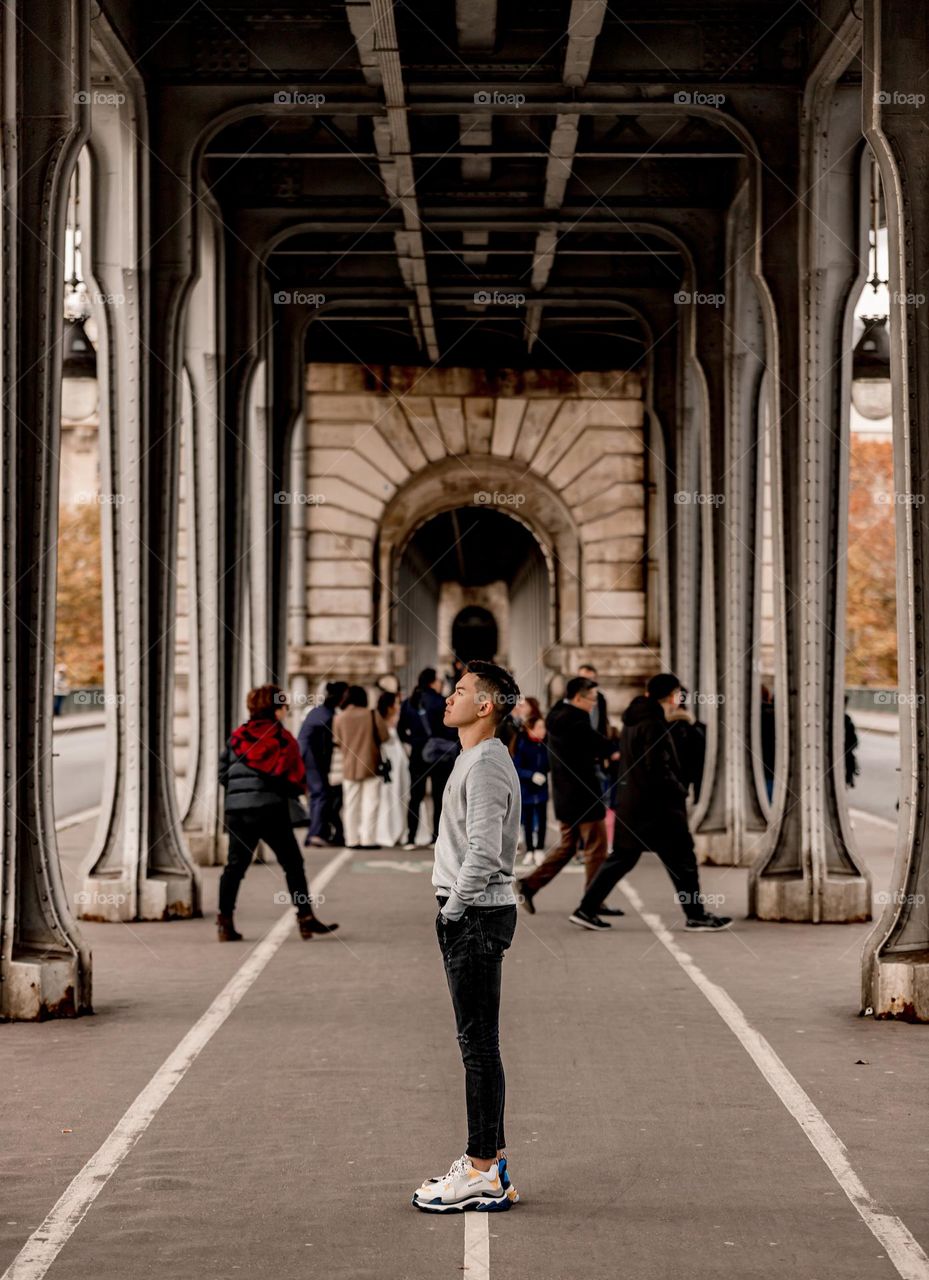 A young man standing in the middle of Inception Bridge , Pont de Bir-Hakeim, Paris, imagining himself as Leonardo walking through the Inception Bridge, with many people come and go besides him ๐ถ๐ปโโ๏ธ
.