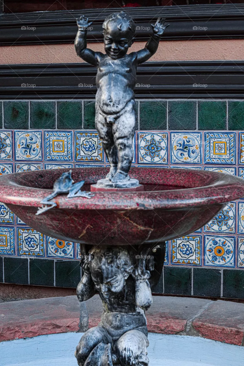 child and frog fountain on the plaza