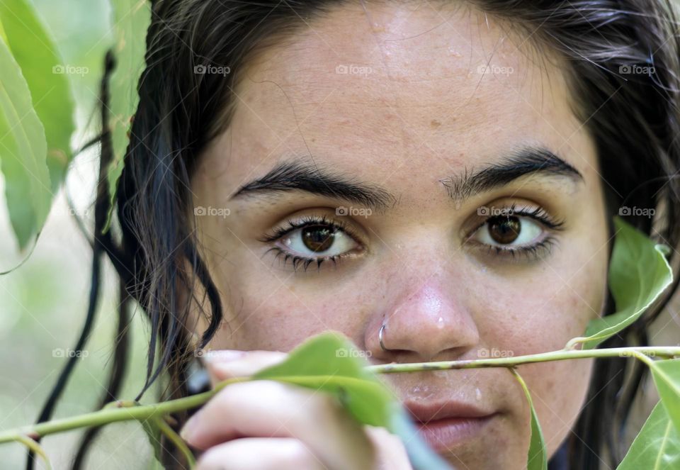 Portrait of a young woman, face still wet from swimming