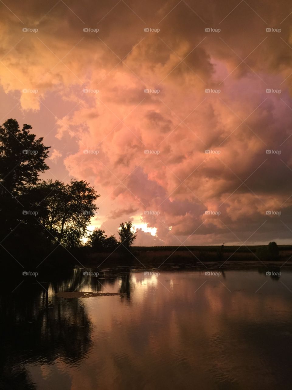 Crimson clouds over pond