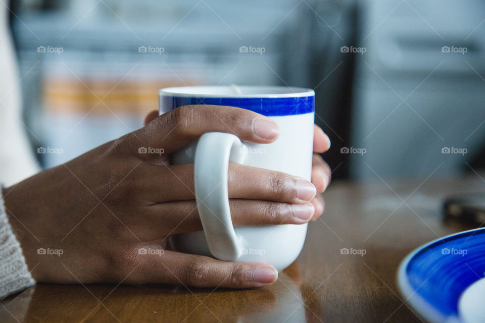 A person holding a tea cup