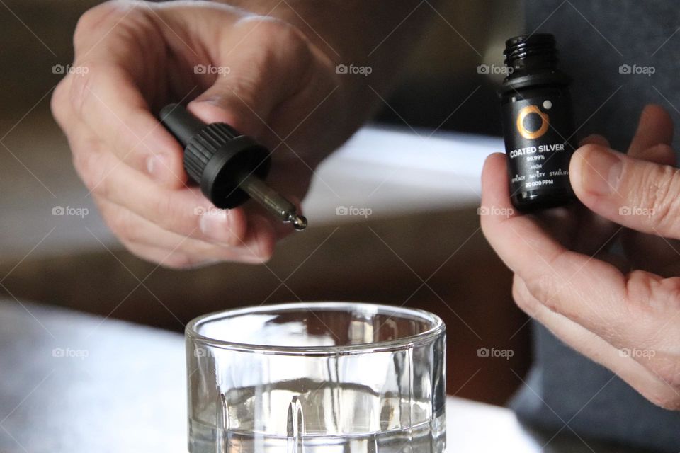 Man holding coated silver product 