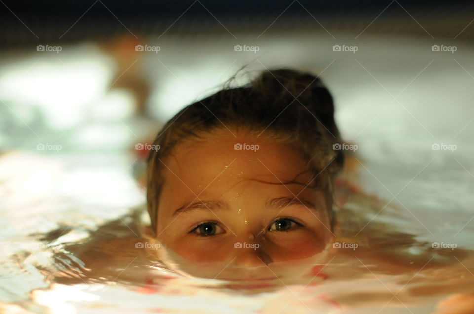 Close-up of a girl swimming in pool