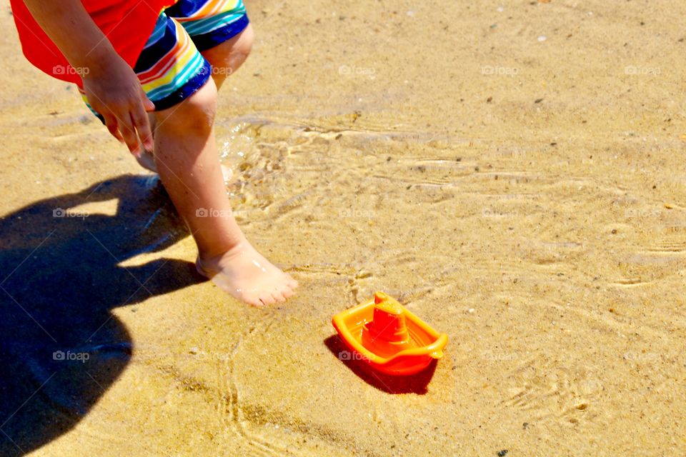 A boy’s orange boat