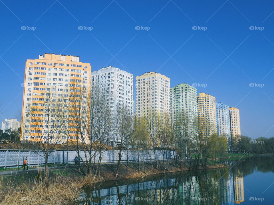 mirror reflection of residential buildings in the lake