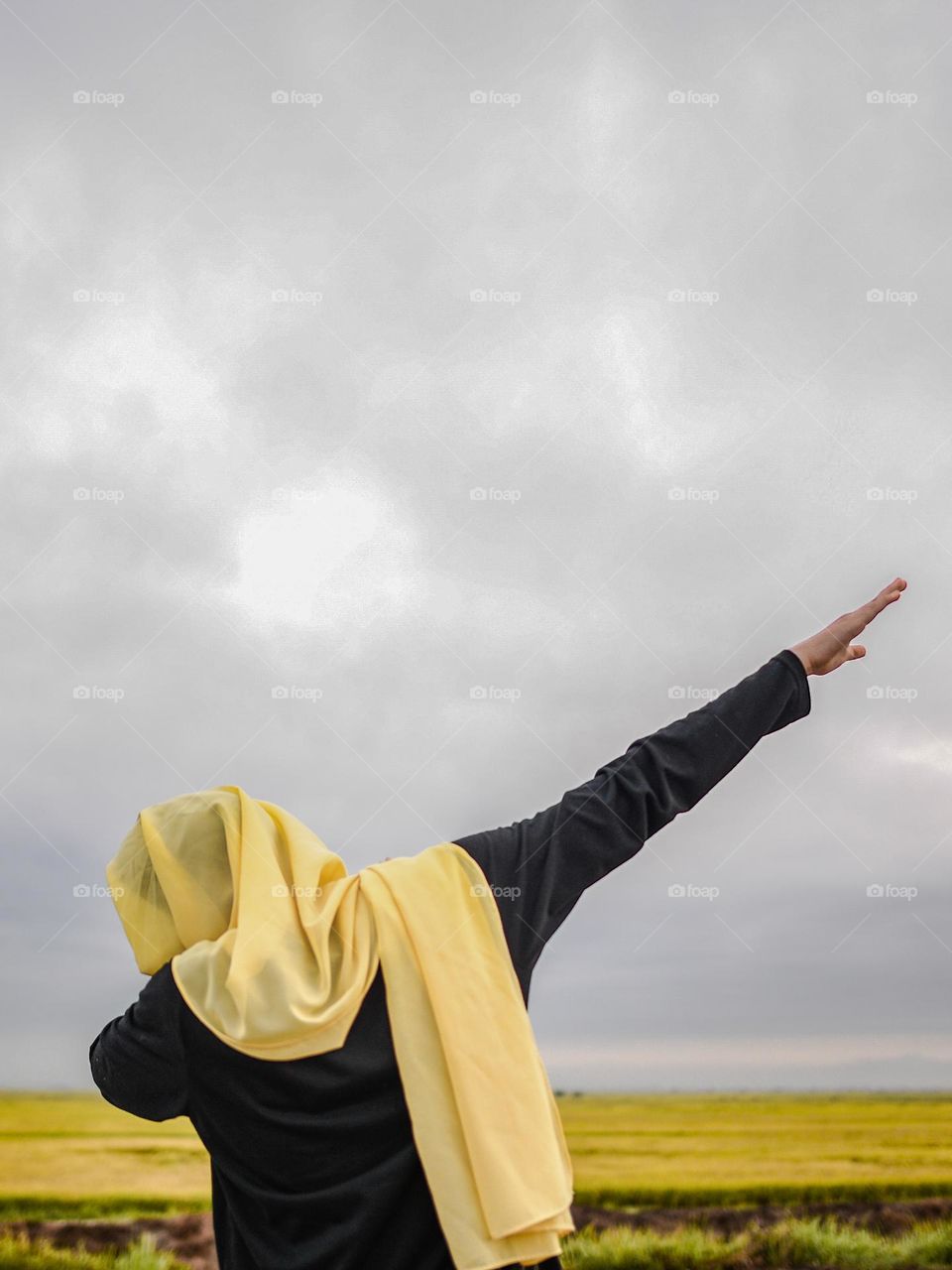 Dancing hand gestures against cloudy sky