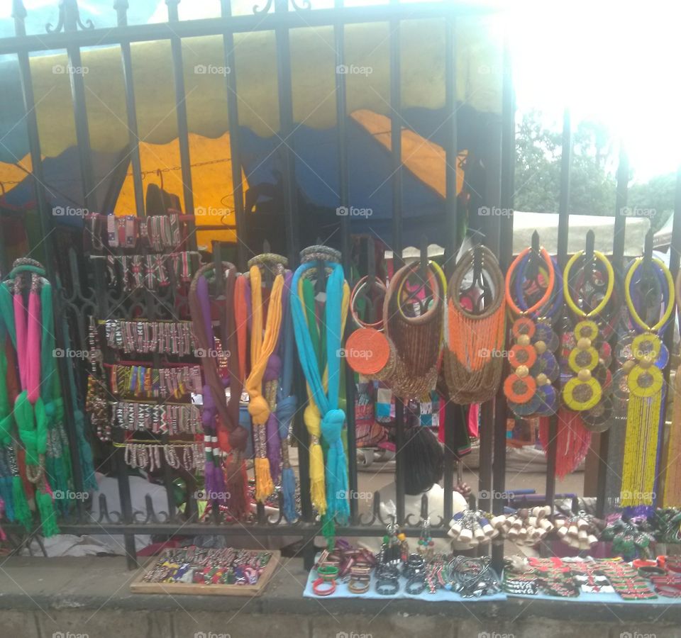This photo shows beautiful African ornaments. They include necklaces, bracelets, anklets, key holders, beaded scarfs etc.