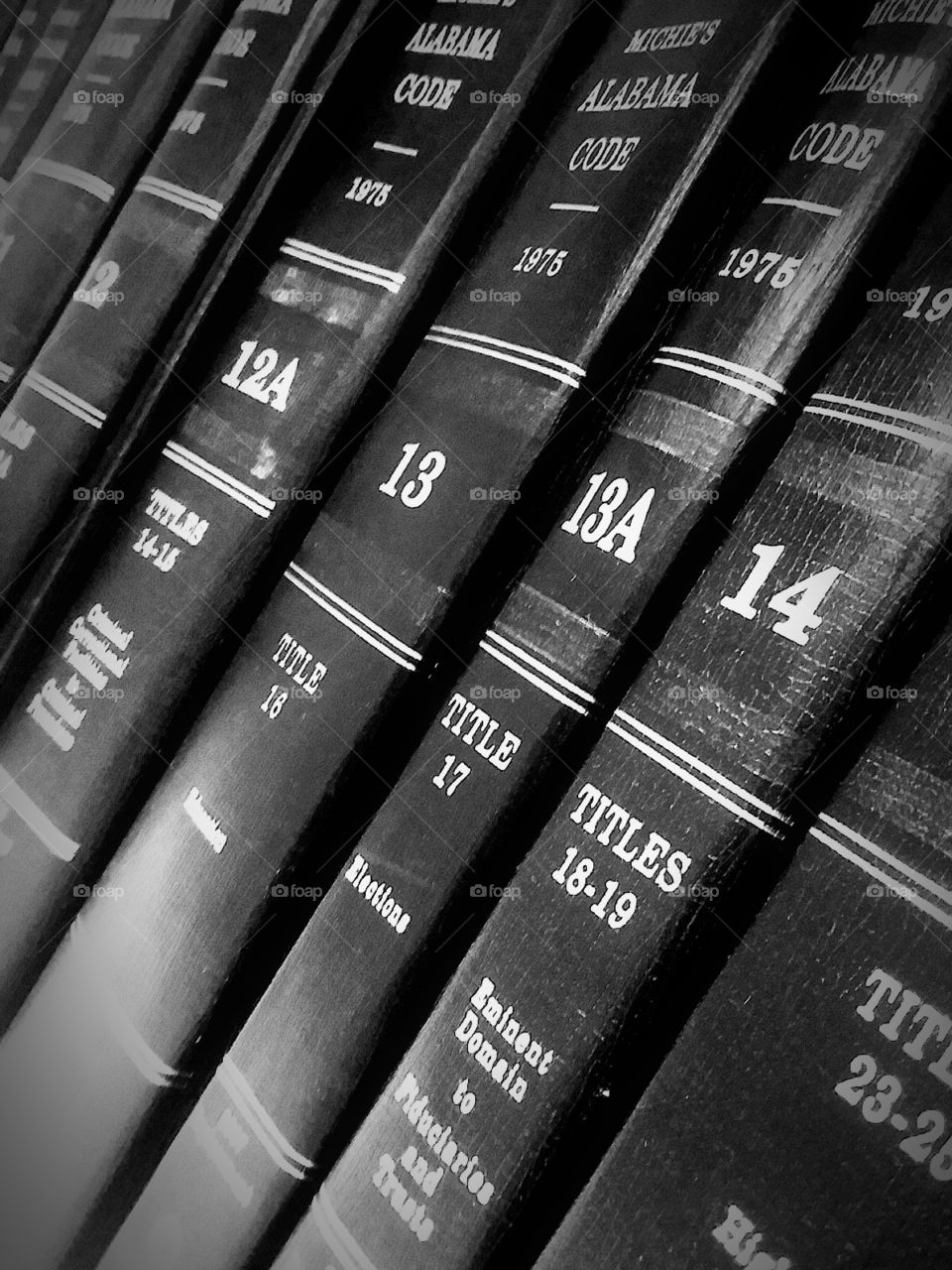 row of symmetrical black and white law books on a shelf