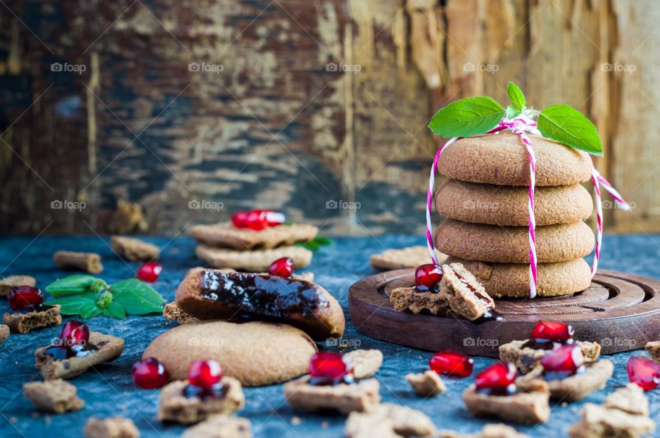 Chocolate filled coco cookies on a rustic wood background.