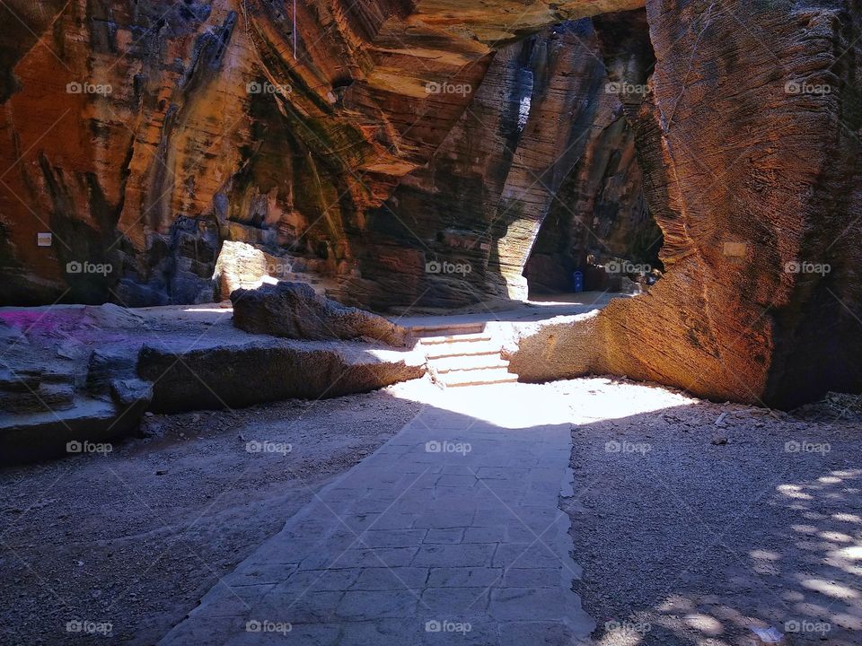 A cave having sunrays from top.