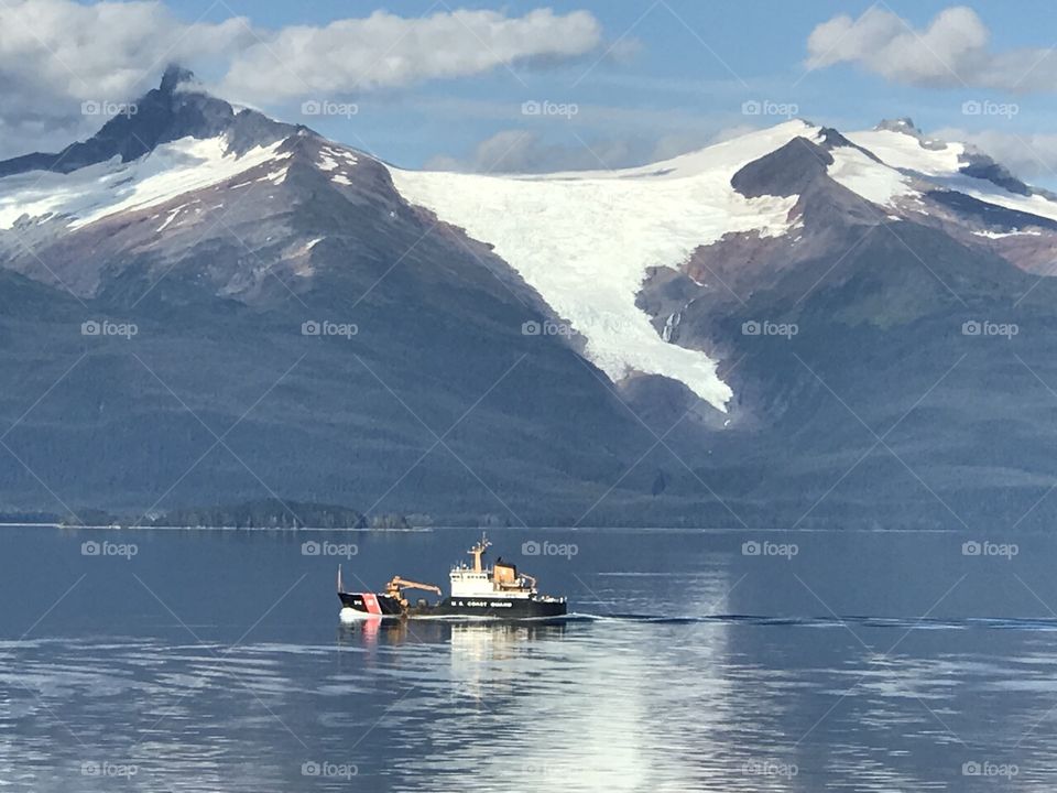 Coast Guard boat passing a glacier