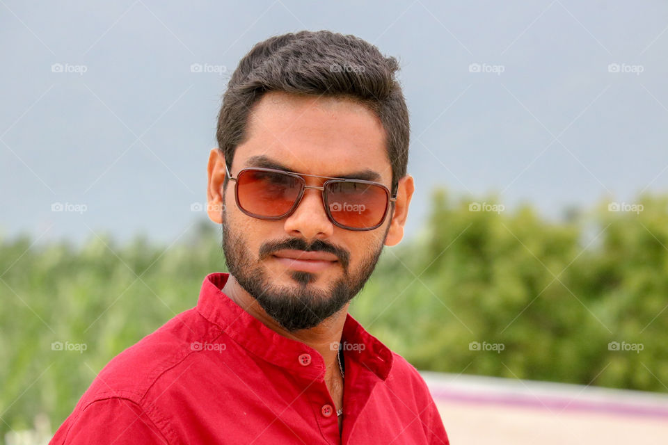 man with red colour sunglasses and beard