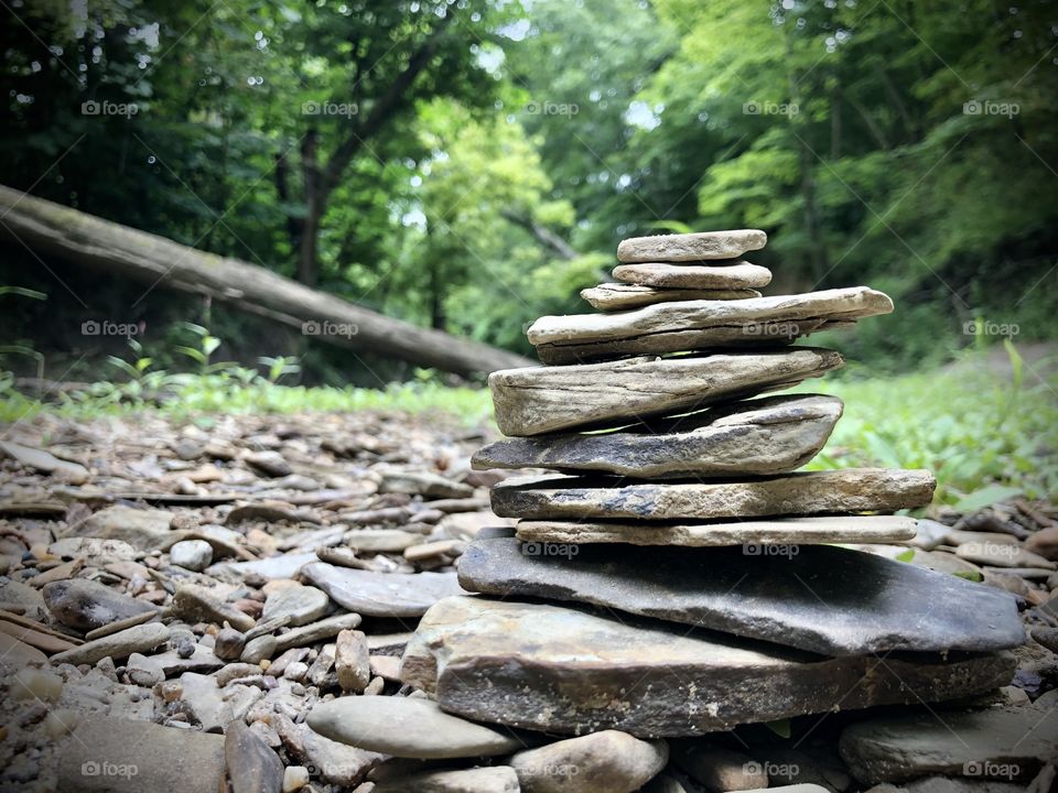 Stones stacked in a dry creek bed