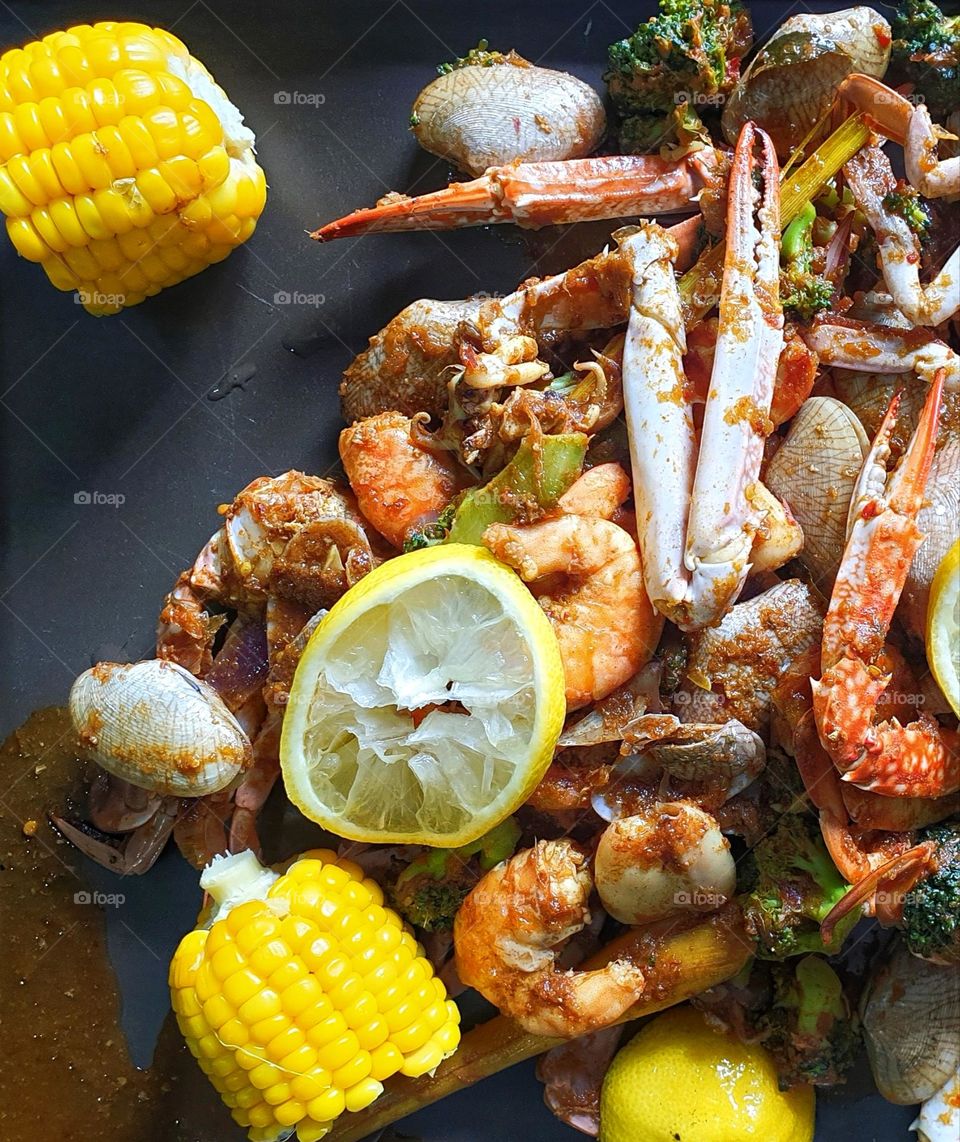 Cajun style seafood serve with hot sauce