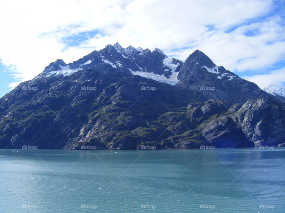 Calm Ocean waters, window view while cruising past glaciers and mountains in Alaska
