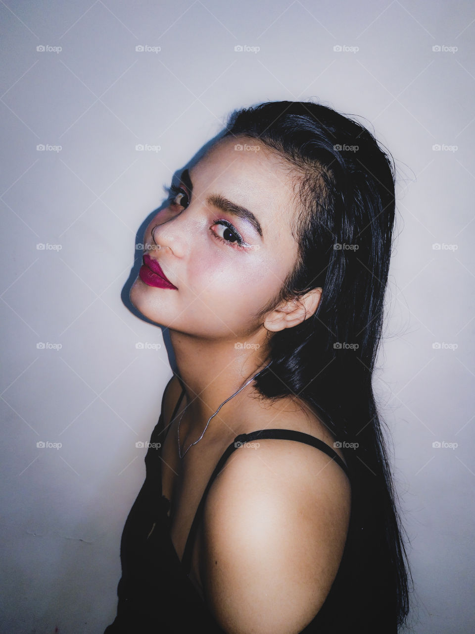 Colored photo, left-side profile showing off Jessa's makeup look.