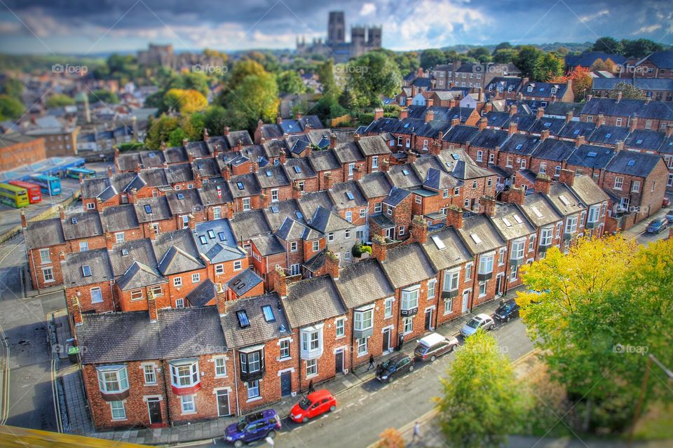 A view of the city of Durham in North East England from the railway viaduct on the East Coast Main Line. Durham Cathedral can be seen in the distance above rows of terraced houses