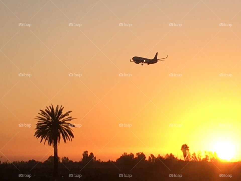 Beautiful airplane flying cross the sky and magic sunset 