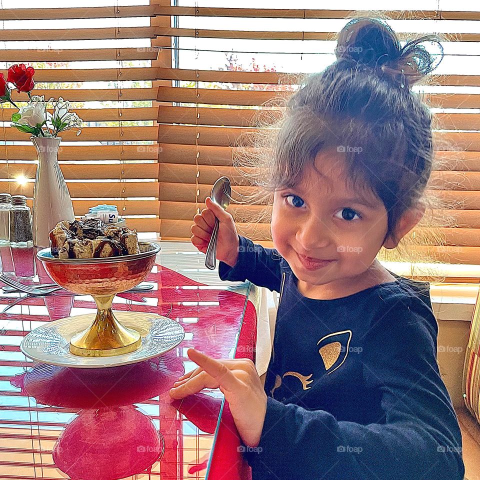 Little girl eats ice cream, little Indian girl dressed up, eating at an Indian restaurant, eating at a fancy restaurant in Ohio, little girl excited about food 