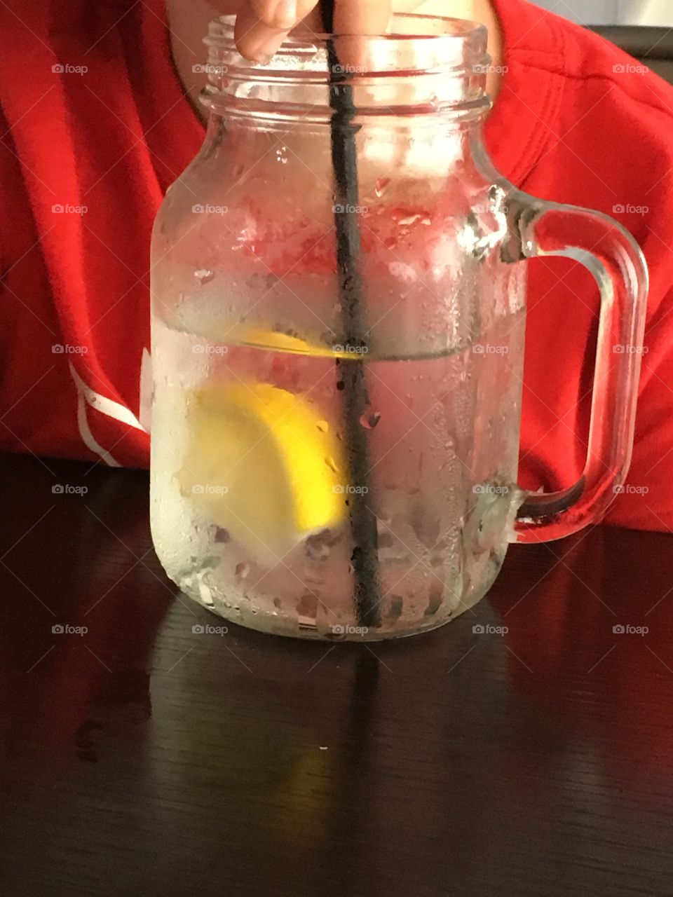 Lemon water in a mason jar glass mug. 