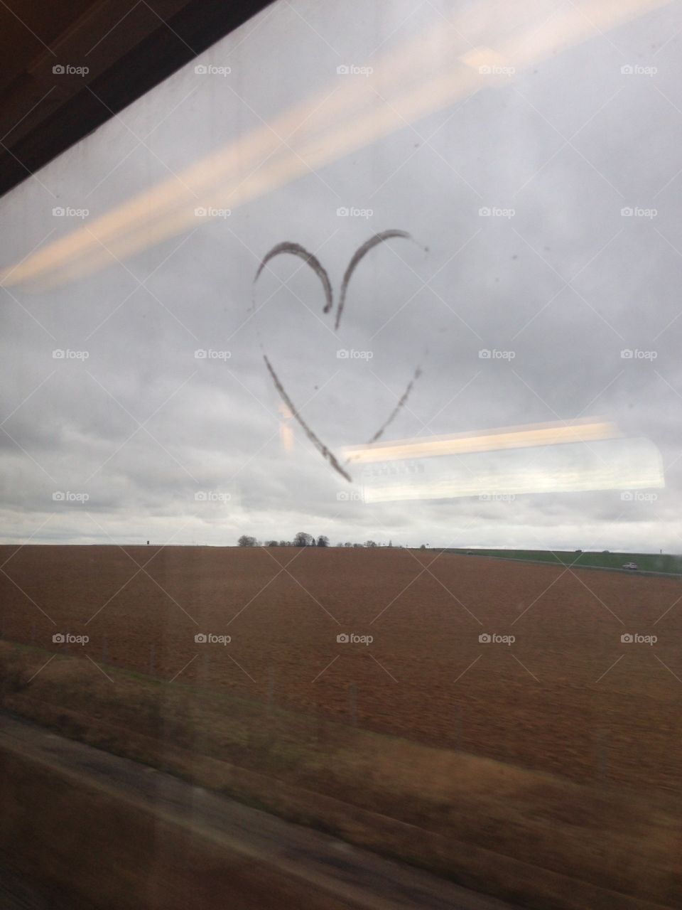 Traced heart on train window. Reims France heart drawn on window overlooking winter fields
