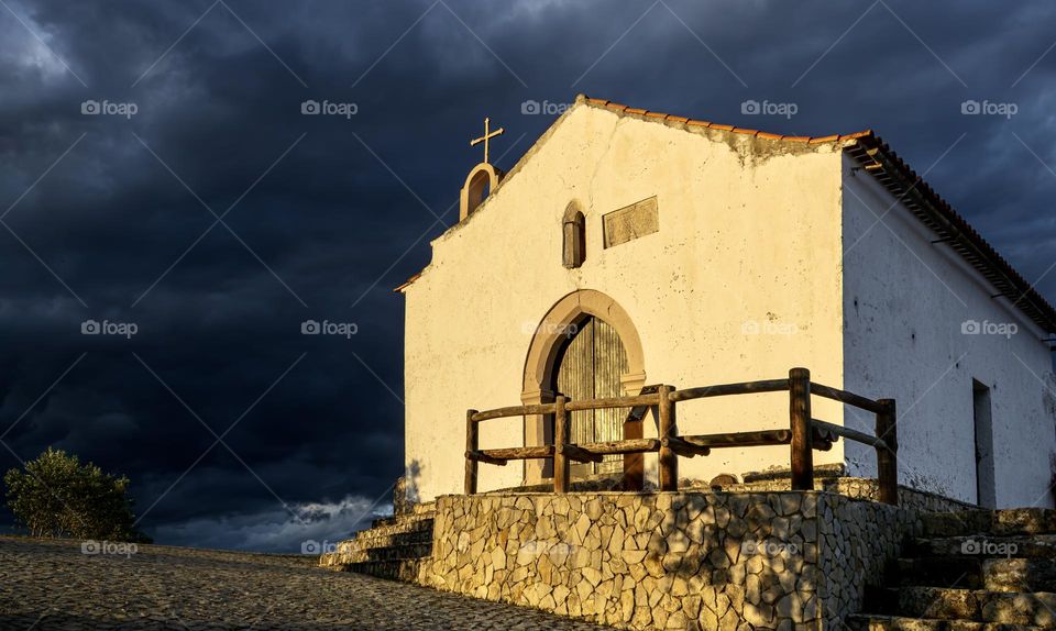 Disused church Sao Pedro do Castro, high on the hill  caught in the fading sunlight as storm clouds roll in behind 👩‍💼